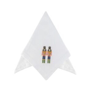 White cotton napkin with festive nutcracker embroidery